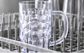Clear handled mug securely loaded in a dishwasher rack